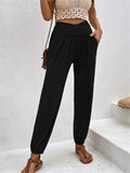 Casual loose pocket ankle-tied trousers by Spacewallart, featuring relaxed fit, ankle ties, and side pockets, worn with a casual top.