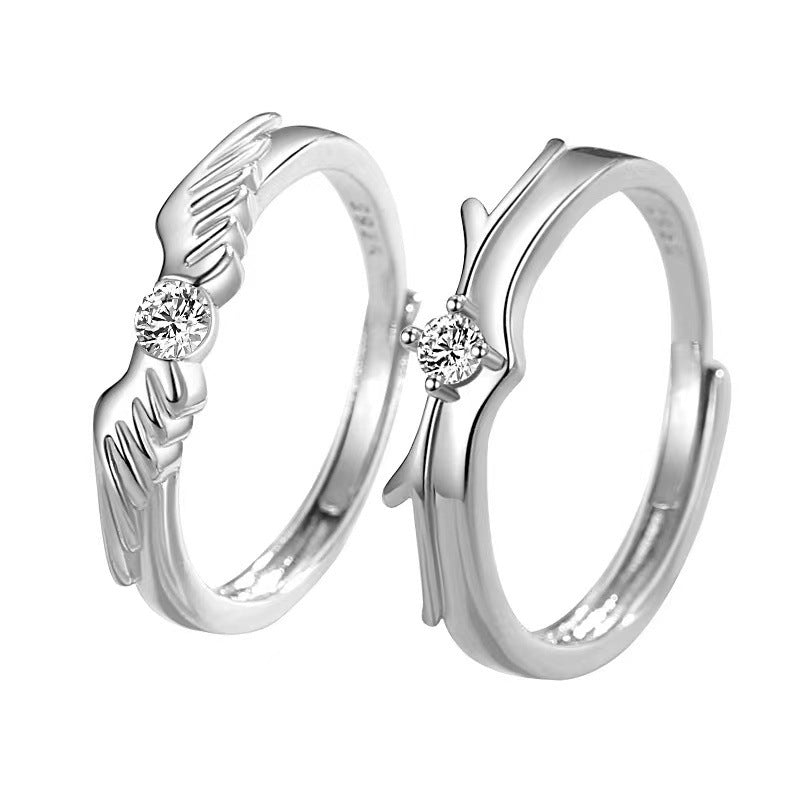 Pair of silver flying couple rings from Spacewallart, featuring detailed wing designs, displayed on a neutral background.