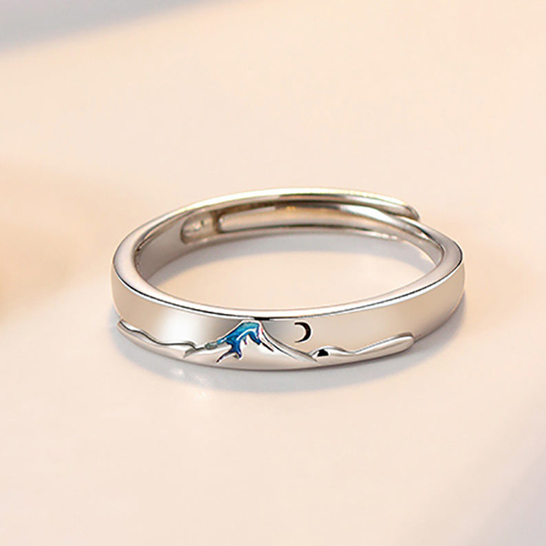 Pair of matching couple's rings from Spacewallart, silver-toned accessories with engraved details, displayed on a neutral background.