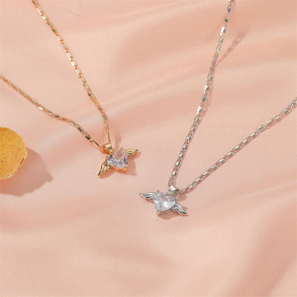 Spacewallart Heart Wings Necklace, delicate accessories with a heart and wing design, featuring intricate metal detailing.
