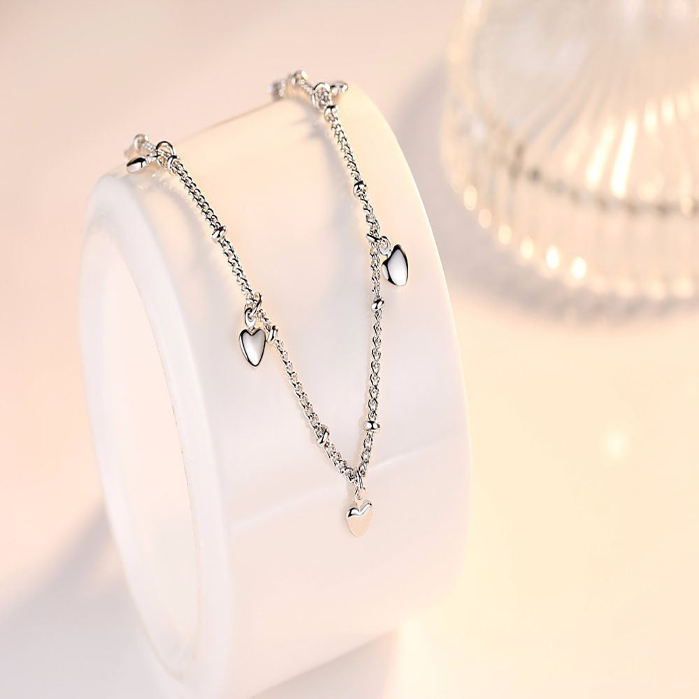 Sterling silver bracelet from Spacewallart showcasing a sleek, polished design in a close-up view of the accessories.