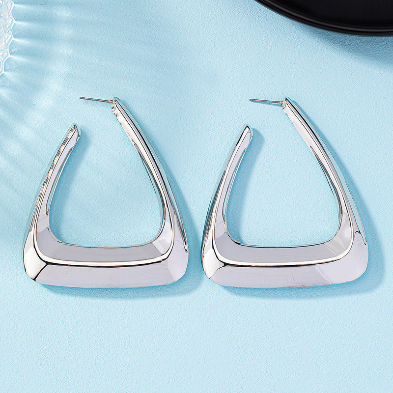 Spacewallart metal earrings for women, stylish accessories with geometric design, silver finish, and hoop style.