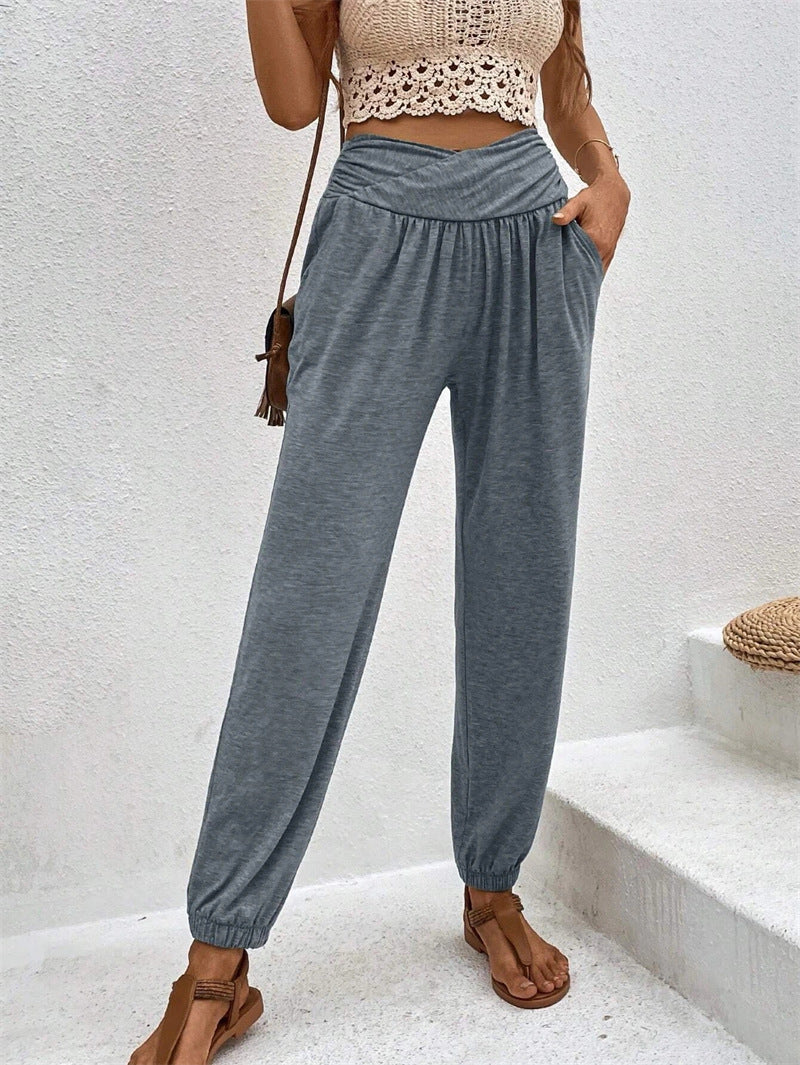 Casual loose-fit ankle-tied trousers with pockets in beige, by Spacewallart, styled for a relaxed, comfortable look.