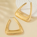 Silver metal earrings for women, stylish accessory by Spacewallart, featuring sleek, modern design on a neutral background.