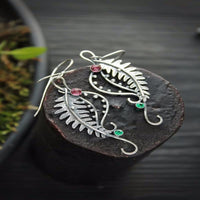 Spacewallart tail shape earrings, stylish accessories featuring unique tail-inspired design, shown in a close-up image.