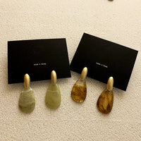 Spacewallart resin acrylic earrings, stylish accessories with vibrant colors and unique design, hanging on display.