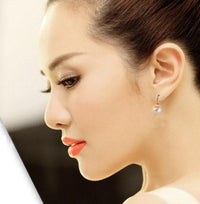 Simple pearl earrings from Spacewallart, elegant accessories with classic white pearls and silver studs.