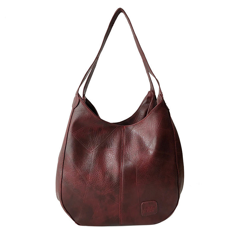 Vintage women's handbag by Spacewallart with leather texture, gold accents, and classic design on a neutral background.