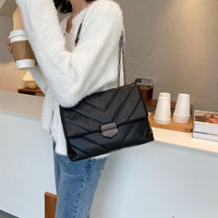 Small PU leather crossbody bag by Spacewallart, featuring a sleek design and adjustable strap for stylish accessories.