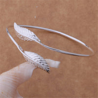 Spacewallart bangle bracelets, stylish jewelry accessories with multiple metallic bangles stacked on the wrist.