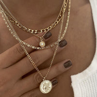 Spacewallart chunky gold necklace with bold, textured links, styled as a statement accessories piece.
