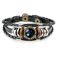 Spacewallart Zodiac Sign bracelet displaying a silver charm with zodiac symbol on a black leather band.