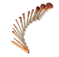 Set of 12 Spacewallart beauty makeup brushes with various brush heads for foundation, eyeshadow, and blending.