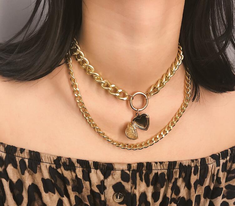 Metal heart choker necklace from Spacewallart, stylish accessories piece with a sleek metallic heart pendant on a black cord.