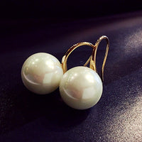 Simple pearl earrings by Spacewallart featuring classic white pearls and silver hooks, elegant and perfect for accessories.