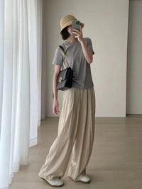 Spacewallart wide-leg pants with a tight waist, loose fit, and flowing fabric, styled as casual apparel for comfort and style.