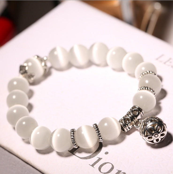 Natural opal beads bracelet from Spacewallart featuring shimmering, colorful gemstones on a delicate string accessory.