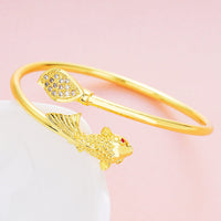Gold color copper bracelet from Spacewallart, stylish accessory with smooth finish and adjustable fit, displayed on a white background.