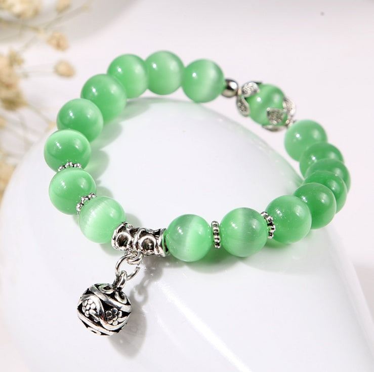 Natural opal beads bracelet featuring colorful, iridescent stones on an elegant accessory from Spacewallart.
