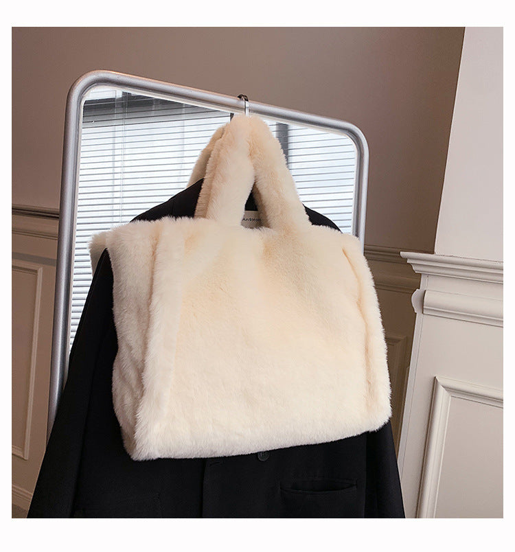 Chain plush handbag by Spacewallart featuring a soft, textured surface and a stylish chain strap for fashionable accessories.