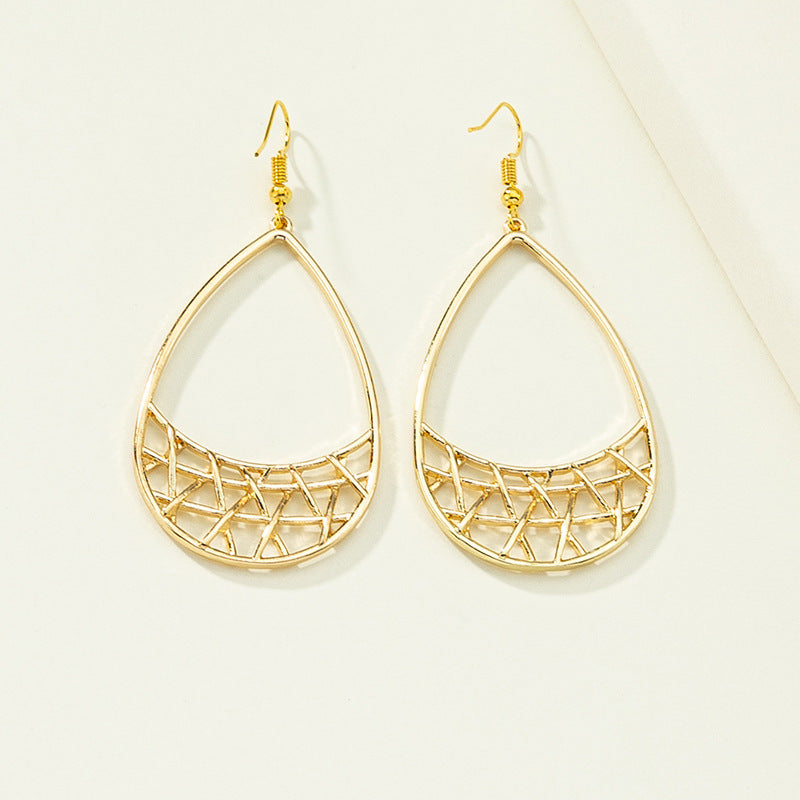 Simple geometric earrings by Spacewallart featuring minimalist shapes and silver-toned metal, displayed on a plain white background.