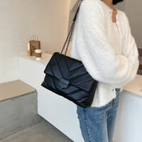 Small PU leather crossbody bag from Spacewallart, featuring a compact design with adjustable strap and sleek finish.