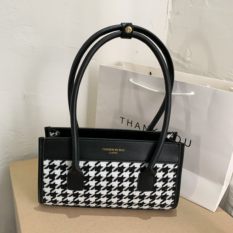 Plaid hand carry bag from Spacewallart's accessories collection, featuring a versatile design with a stylish plaid pattern.