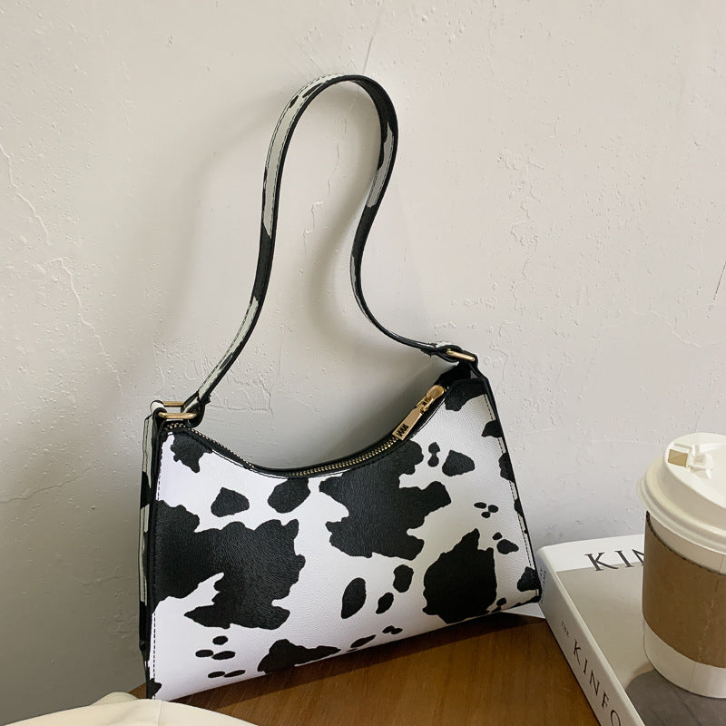 Colorful summer pattern underarm bag by Spacewallart, with stylish design and lightweight fabric accessory for casual outings.