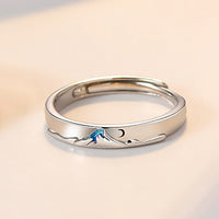 Pair of matching couple's rings from Spacewallart, silver-toned accessories with engraved details, displayed on a neutral background.