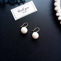 Simple pearl earrings from Spacewallart, featuring classic white pearls and a sleek, minimalist design for elegant accessories.