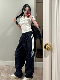 Black casual pants from Spacewallart with a relaxed fit and simple design, suitable for everyday wear.