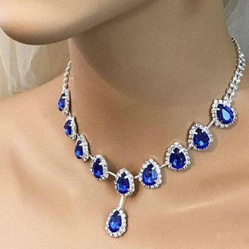 Blue Zirconia Necklace by Spacewallart featuring a sparkling blue zirconia pendant on a delicate chain.