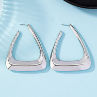Silver metal earrings for women, stylish accessories featuring geometric designs from Spacewallart.