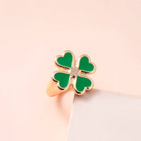 Spacewallart four leaf clover rings, delicate silver accessories with four-leaf clover charms, close-up of detailed jewelry.