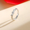 Pair of flying couple rings from Spacewallart, silver-toned accessories with intricate wing details, suitable for couples or fashion accents.