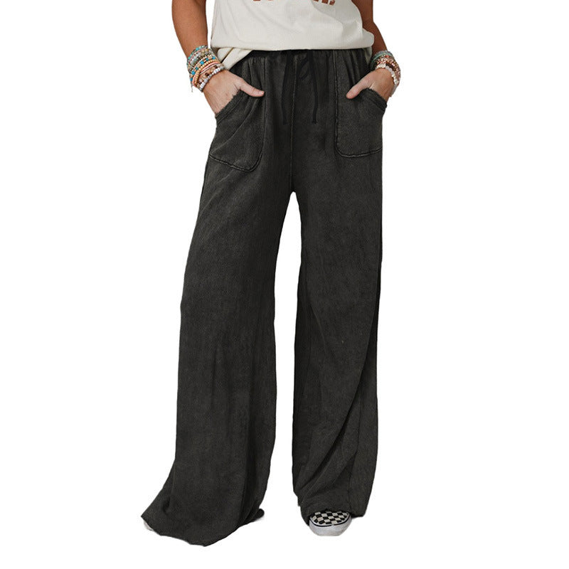 Light washed casual drawstring pants from Spacewallart, with a relaxed fit and comfortable waistband, displayed laid flat.