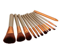Set of 12 Spacewallart makeup brushes with various brush types for beauty application, displayed in a tidy arrangement.