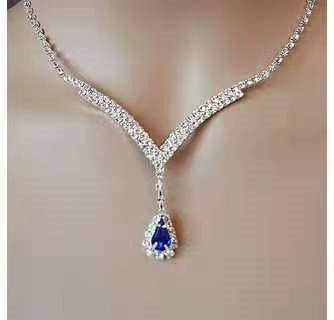 Blue Zirconia Necklace from Spacewallart, showcasing a sparkling silver chain with a vibrant blue zirconia pendant.