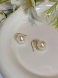 Simple pearl earrings by Spacewallart, featuring classic white pearls on delicate silver hooks for elegant accessories.