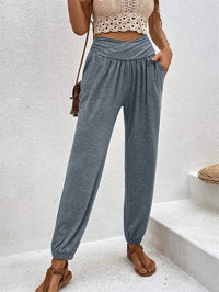 Casual loose-fit ankle-tied trousers with pockets in beige, by Spacewallart, styled for a relaxed, comfortable look.