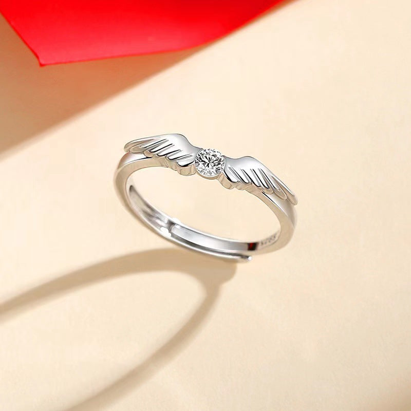 Two silver flying couple rings from Spacewallart's accessories collection, featuring detailed wing designs and polished finishes.