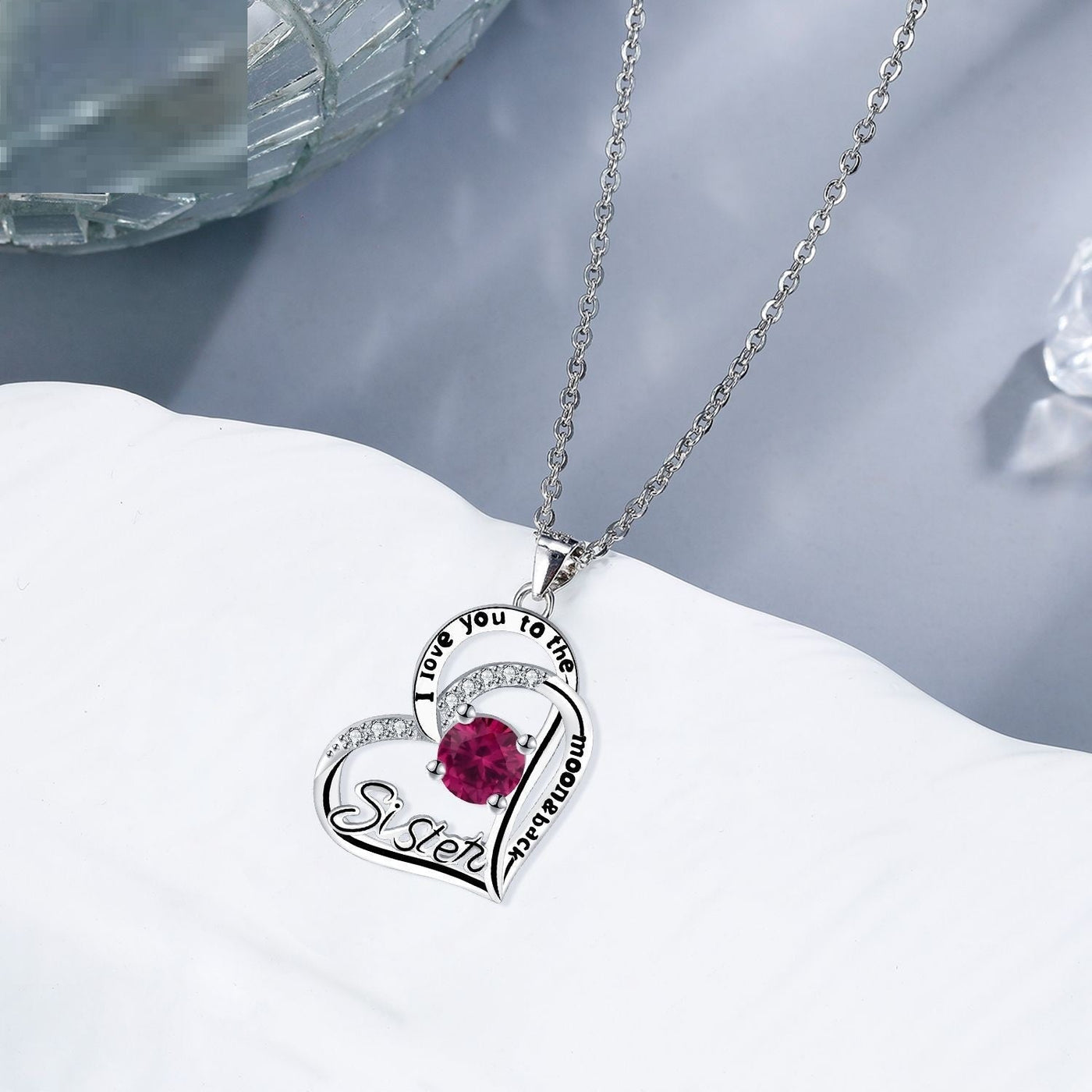 Silver sister necklace from Spacewallart, featuring a delicate chain and pendant, styled as elegant accessories for special occasions.