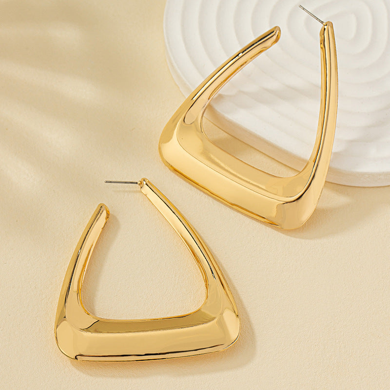 Silver metal earrings for women, stylish accessory by Spacewallart, featuring sleek, modern design on a neutral background.