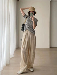 Spacewallart loose wide-leg pants with a tight waist, showcasing flowing fabric and relaxed fit in a stylish apparel image.
