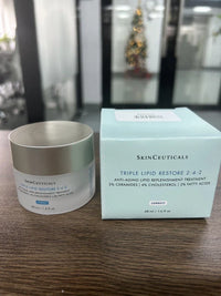 SkinCeuticals Triple Lipid Restore anti-aging face cream in a 1.6 oz jar, featuring a smooth, luxurious skincare formulation.