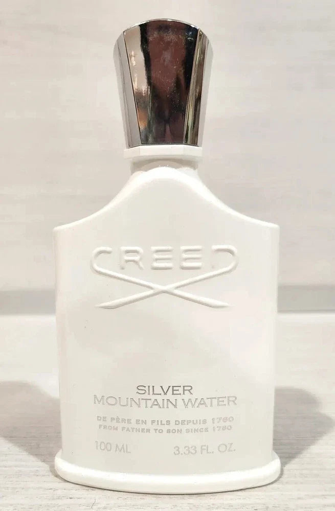 Creed Silver Mountain Water Eau de Parfum by Spacewallart, 3.3 oz bottle, elegant glass container with silver accents.