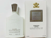 Creed Silver Mountain Water Eau de Parfum unisex bottle, 3.3 oz, with sleek glass design and silver accents.