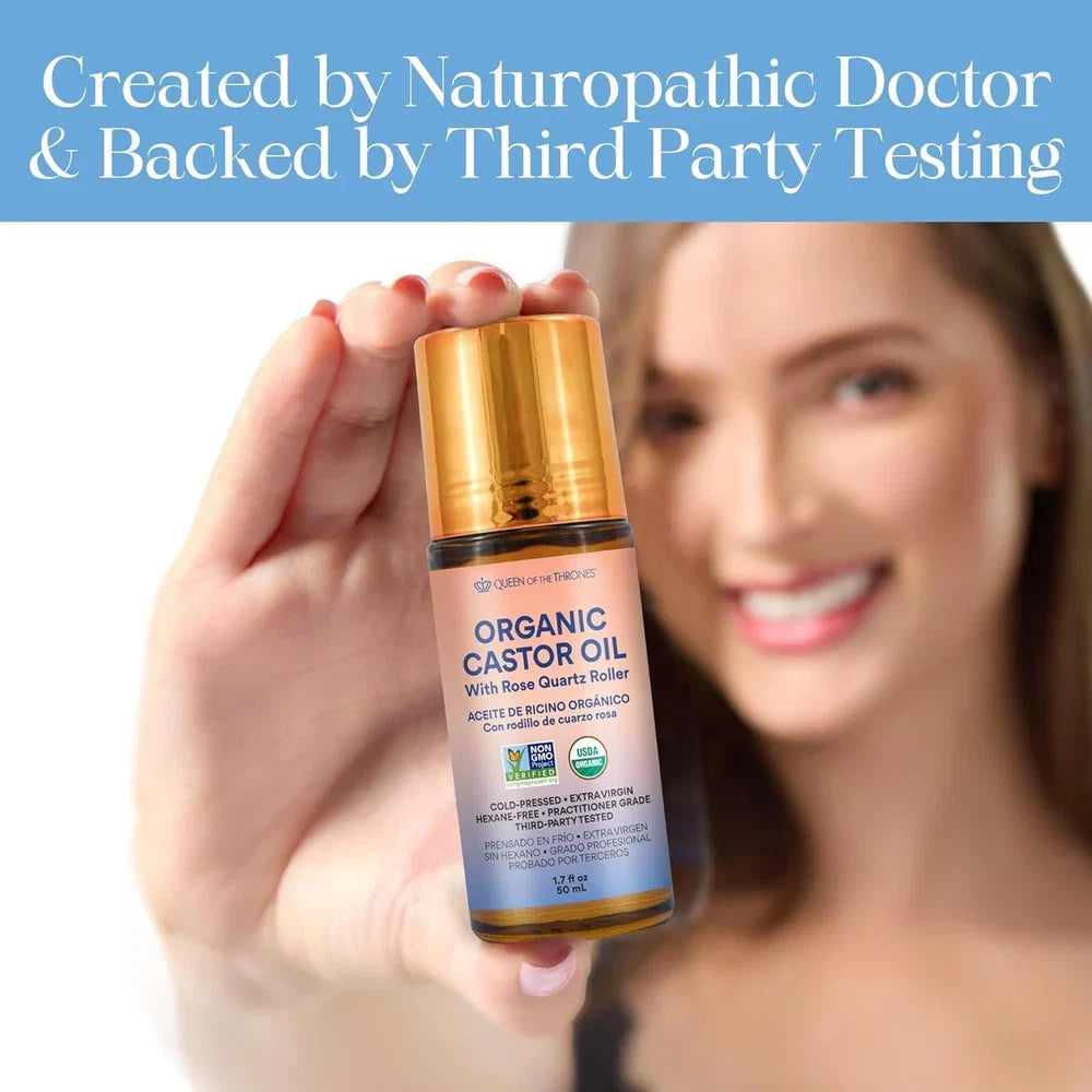 Queen of the Thrones organic golden castor oil roll-on with rose quartz in a 50ml glass bottle, USDA certified, for beauty use.