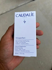 Caudalie Vinoperfect Brightening Dark Spot Serum in 1 oz bottle, featuring clear glass packaging and dropper applicator.