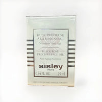Sisley Black Rose Precious Face Oil bottle with black and gold packaging, 0.84 oz/25ml, displayed on a neutral background.